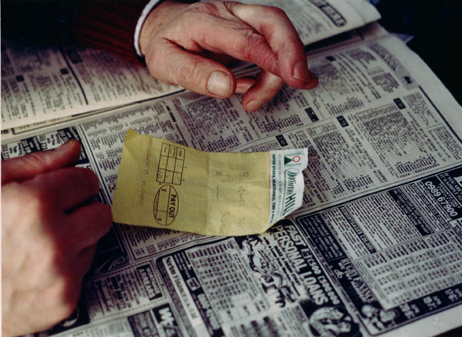 Worker's hands and betting slip